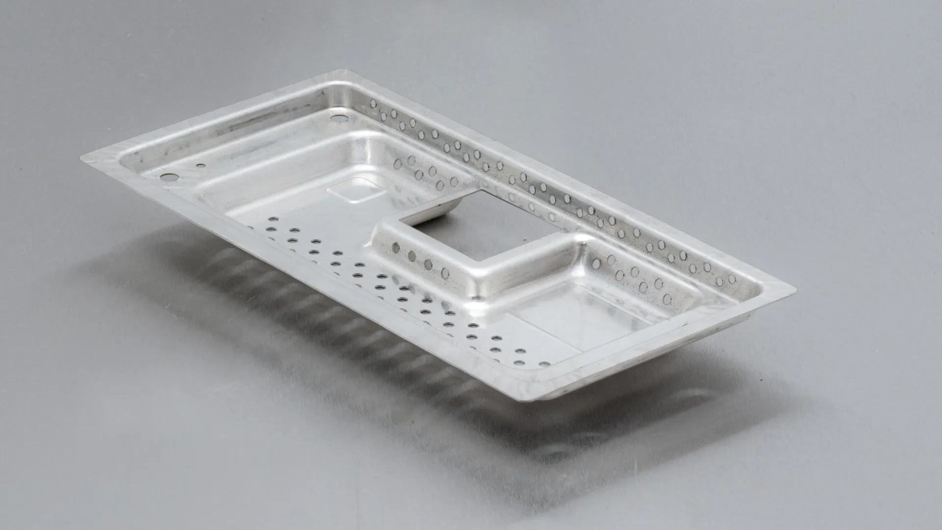 Umgeformte Abdeckung aus Aluminiumblech mit Lochbild